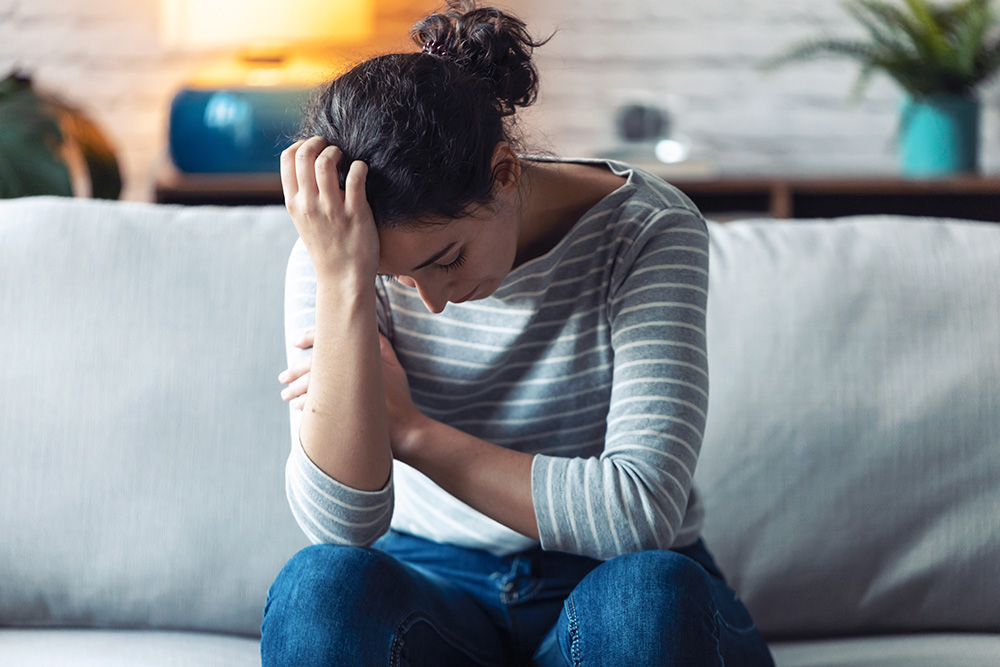 Person experiencing fatigue, a common symptom of vitamin D deficiency